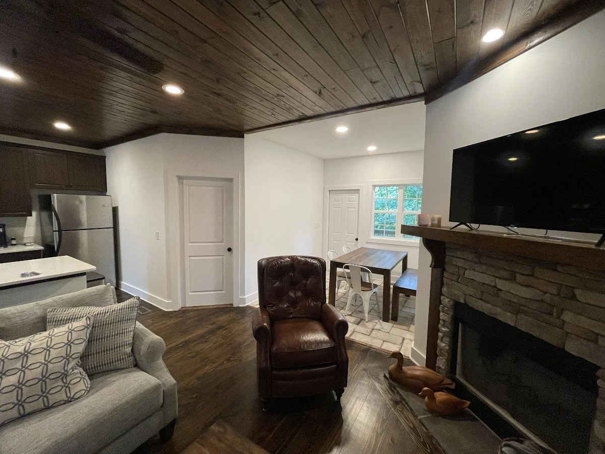 Finished living room with wood-plank ceiling and stone fireplace, Fairway Drive, Auburn AL