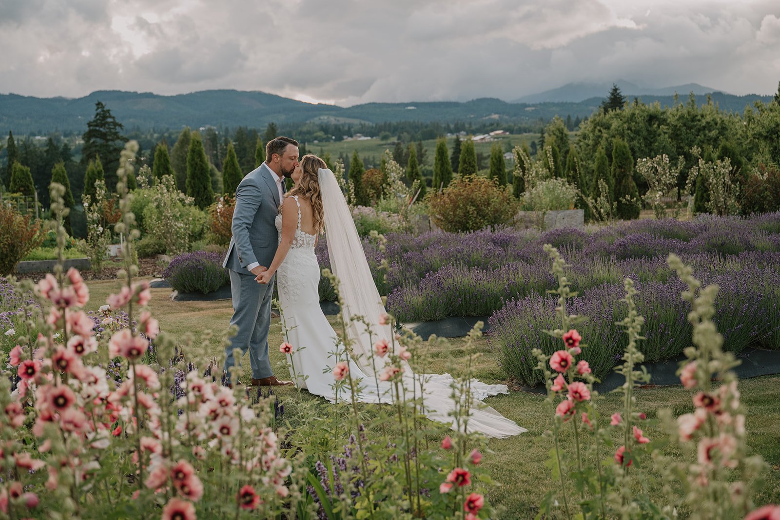 Romantic golden hour wedding portrait of a couple surrounded by lush garden in the Columbia River Gorge