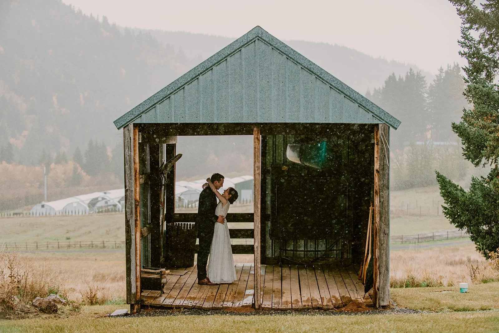 Bride and groom rainy wedding day portrait by Jen Jones Weddings