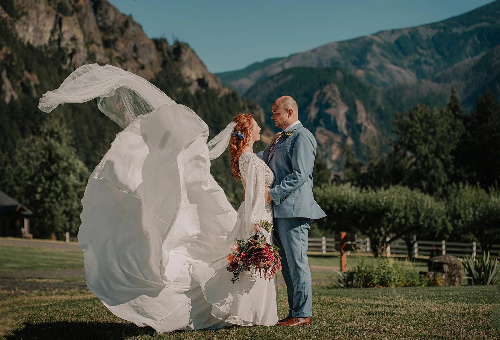 Wedding portrait in the Columbia River Gorge with dramatic cliffs, wind, and natural light.