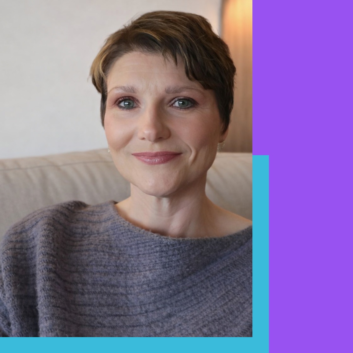 Woman smiling wearing a purple sweater
