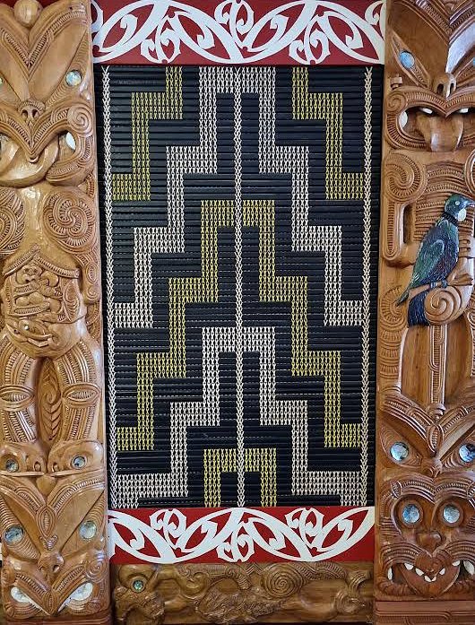 Traditional Maori carving with intricate patterns and woven design