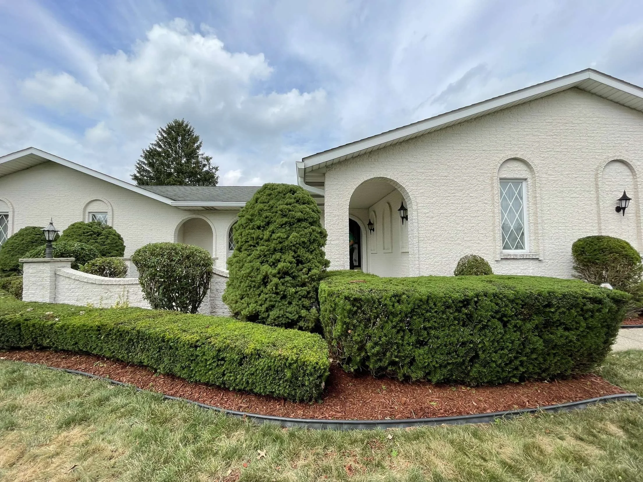 Finely pruned shrubs in a residential landscape bed in Aurora, OH.