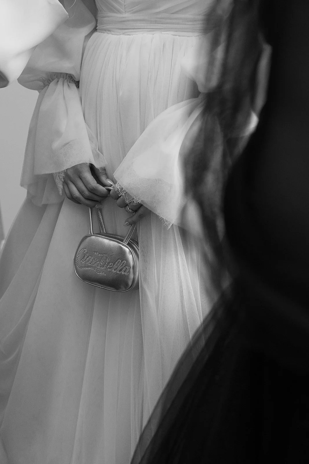 Elegant bridal details featuring a wedding gown and personalised handbag, captured by a Sydney wedding photographer in an editorial style.