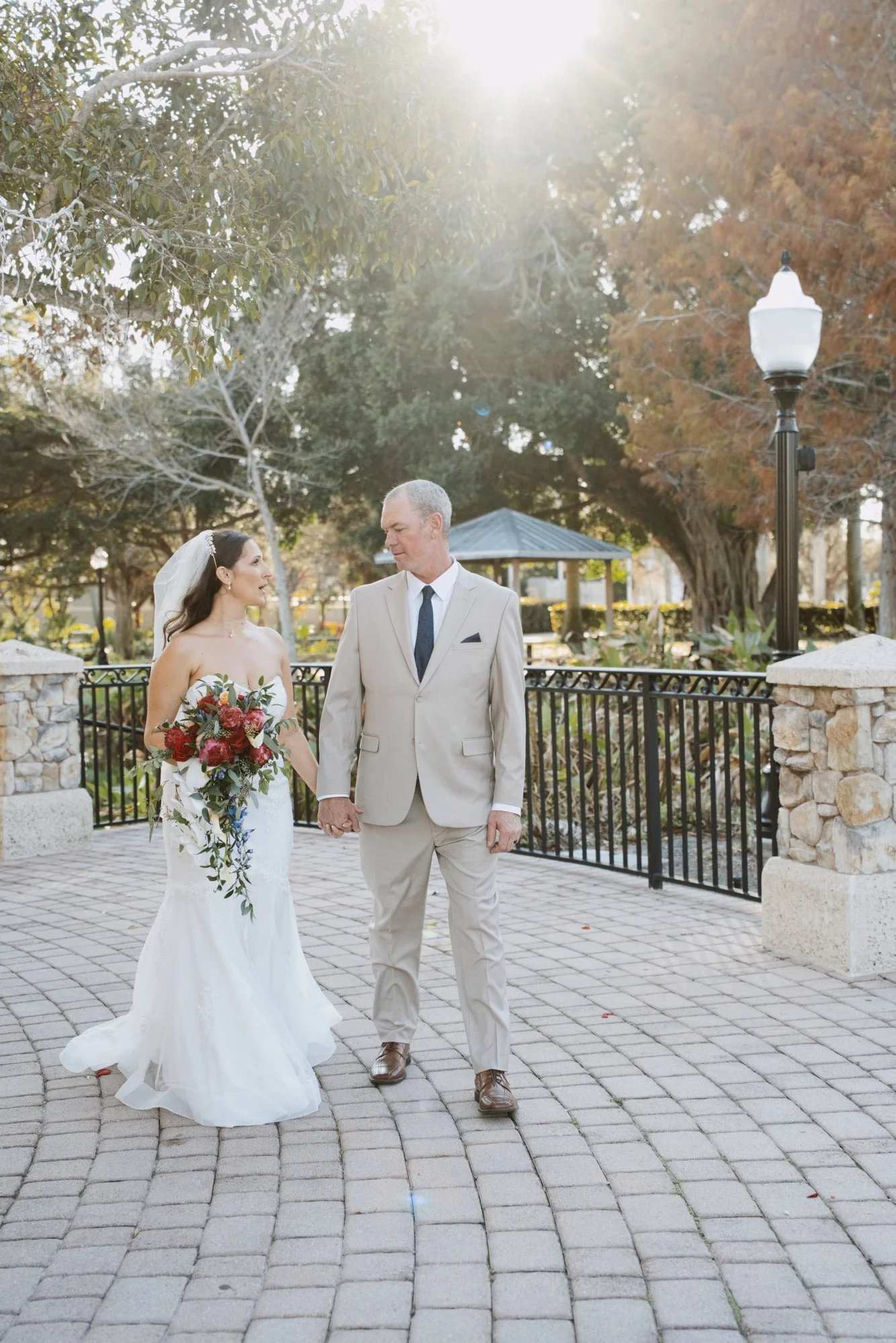 Bride and groom walking hand in hand in golden afternoon light in Stuart, Florida