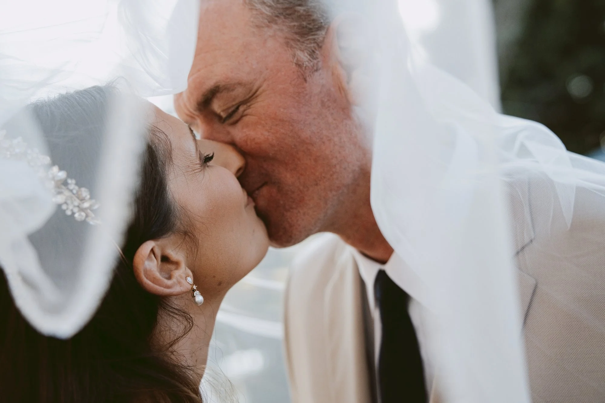 Newlyweds kissing under the bride's veil, Stuart courthouse wedding