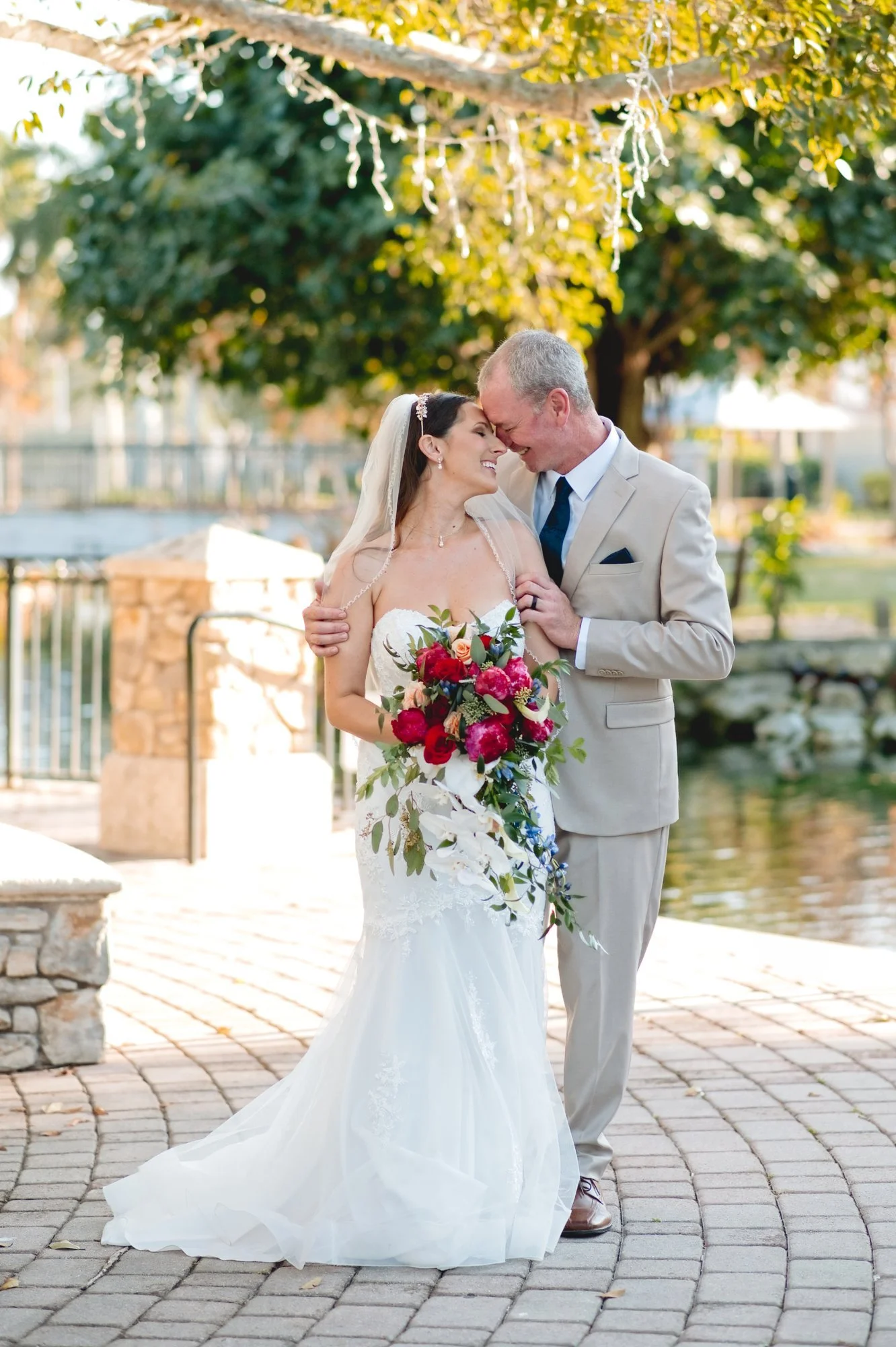 Couple touching foreheads beside the water at Memorial Park in Stuart