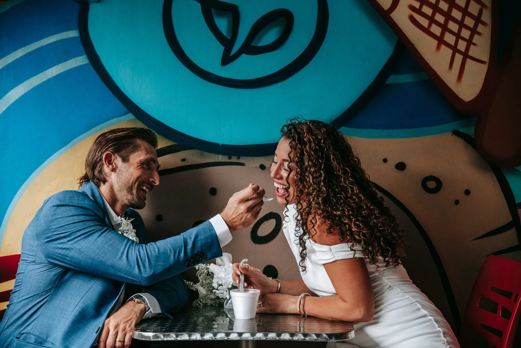Couple laughing over ice cream in the Pineapple Grove Arts District after their Delray Beach courthouse wedding
