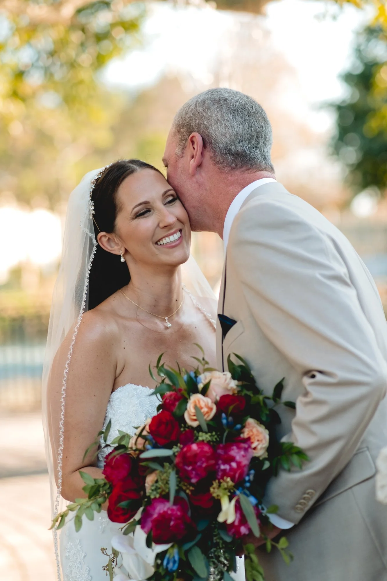 Bride laughing as her new husband kisses her temple at their Stuart courthouse wedding