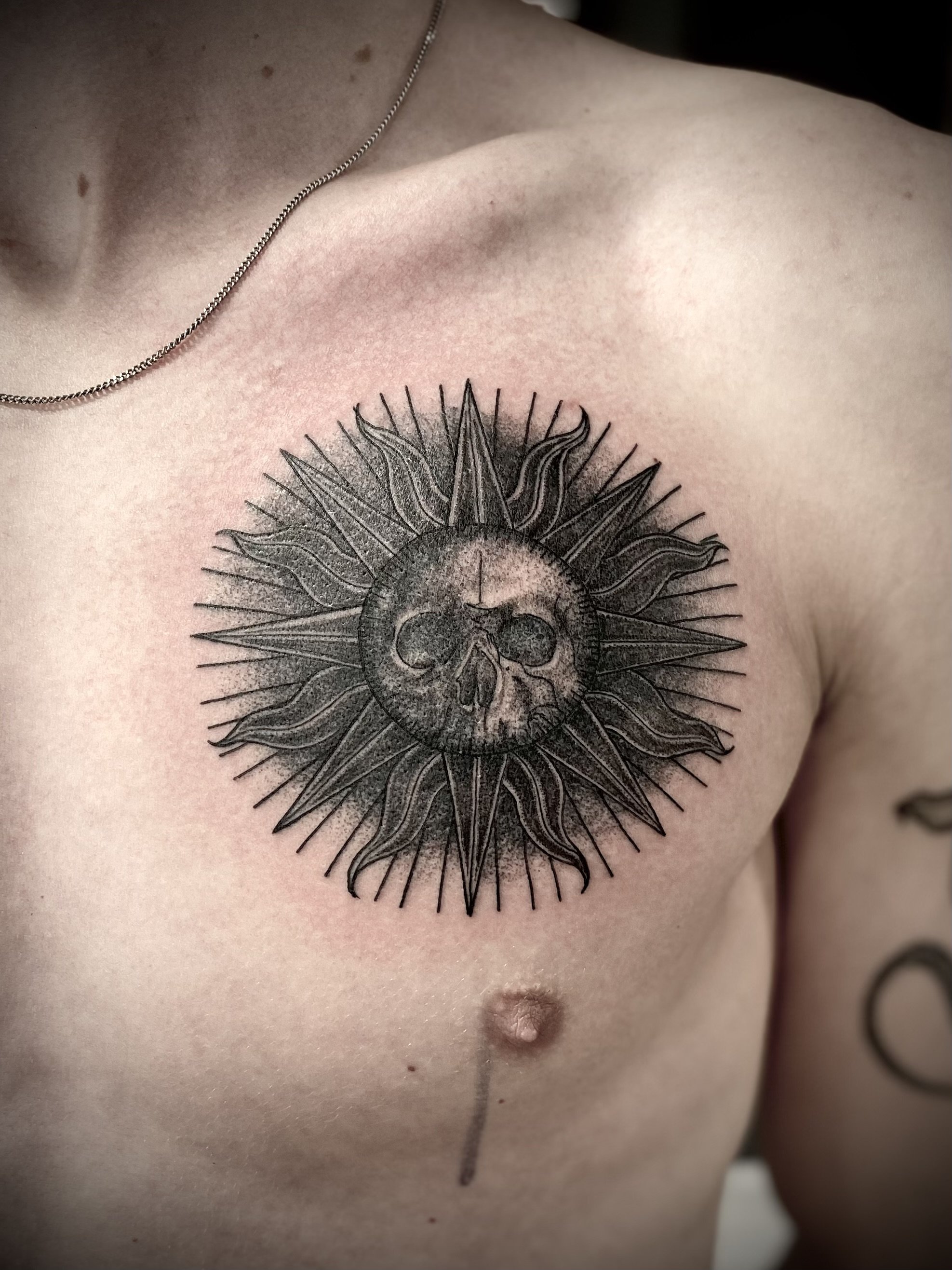 Sun tattoo brisbane chest black grey