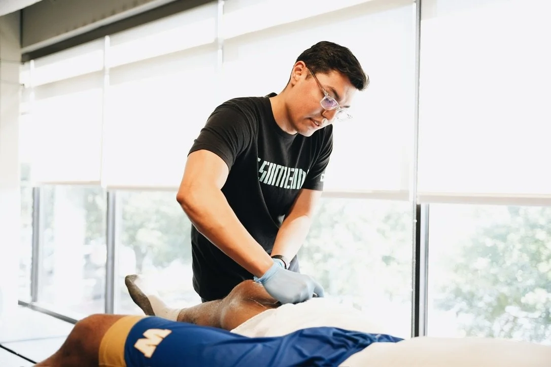 Runner receiving manual therapy treatment at a performance clinic in Tomball