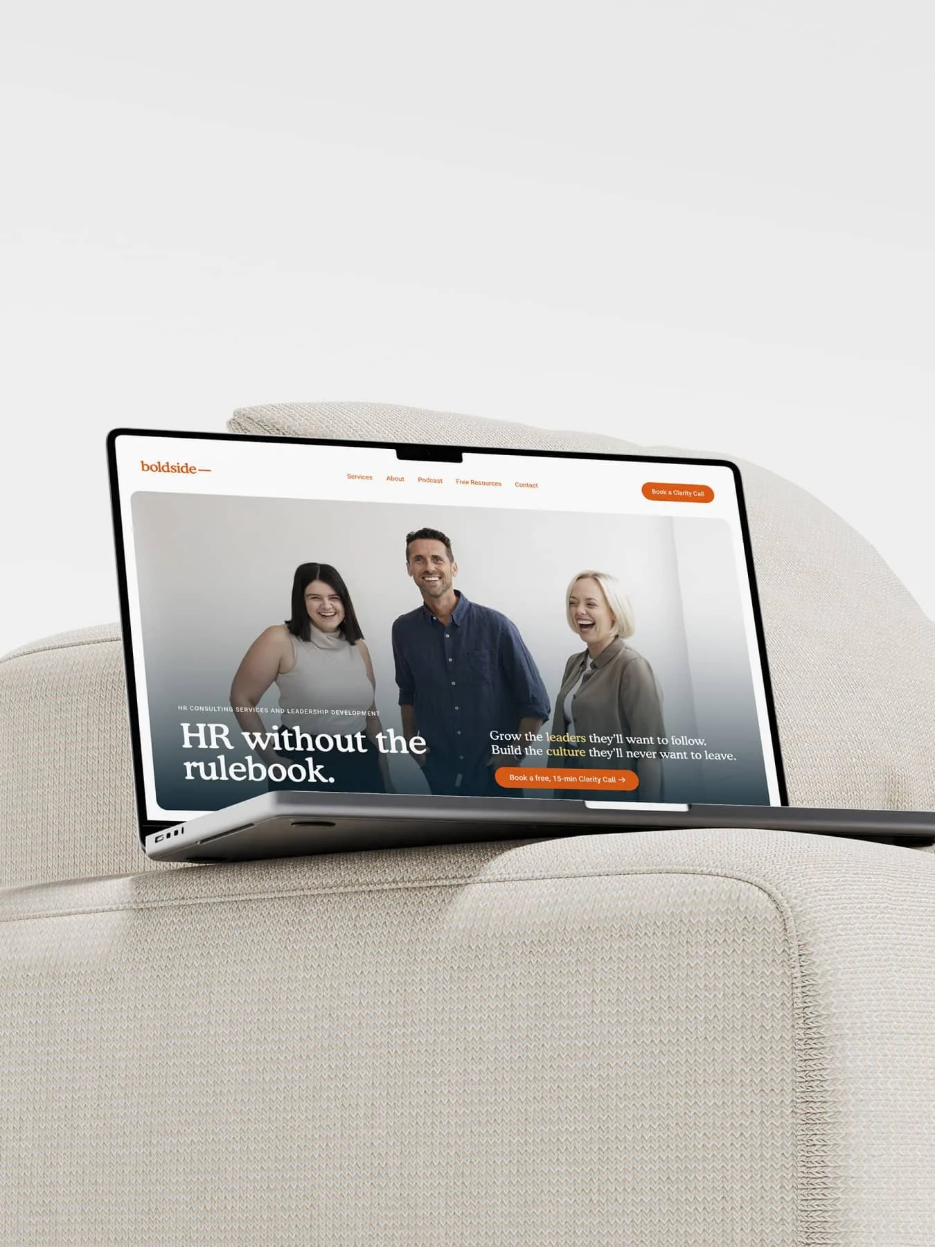 Macbook laptop sitting open on couch showing the website design of Boldside, an HR consulting firm in Sydney