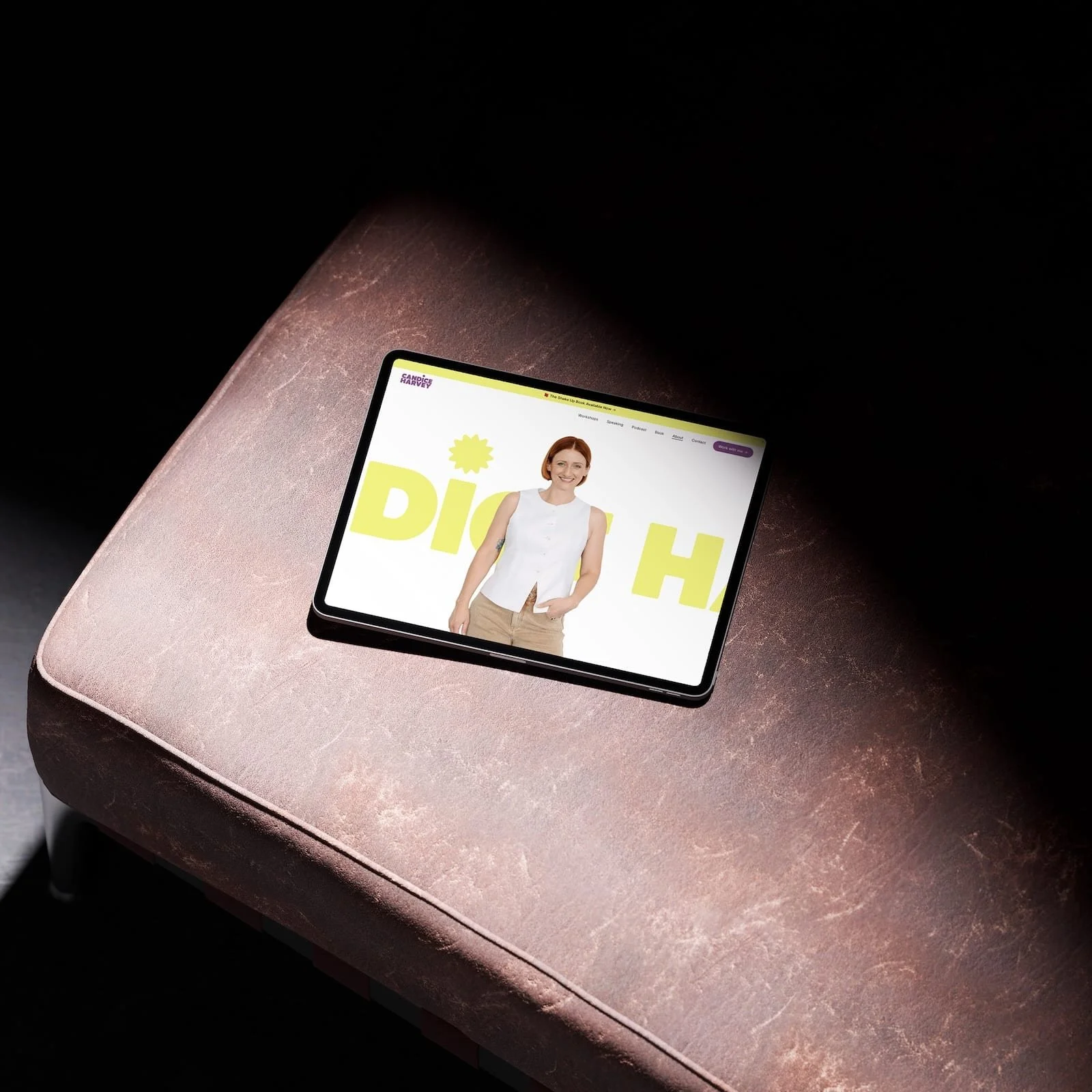 iPad and iPhone on a couch, showing web design for Candice Harvey performance training workshop facilitator