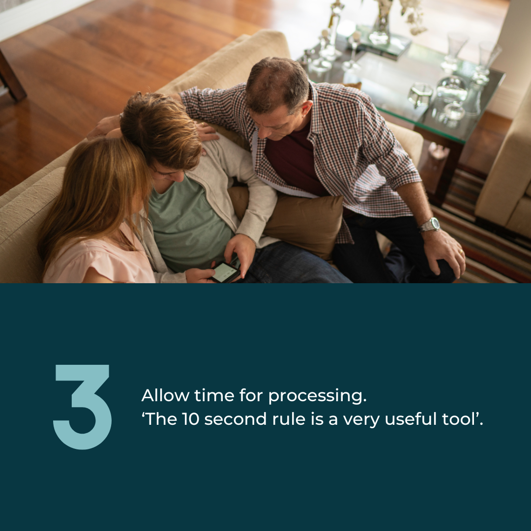  3: Allow time for processing. ‘The 10 second rule is a very useful tool’. Photo of two White parents sat on the couch with their teenage son, talking. 