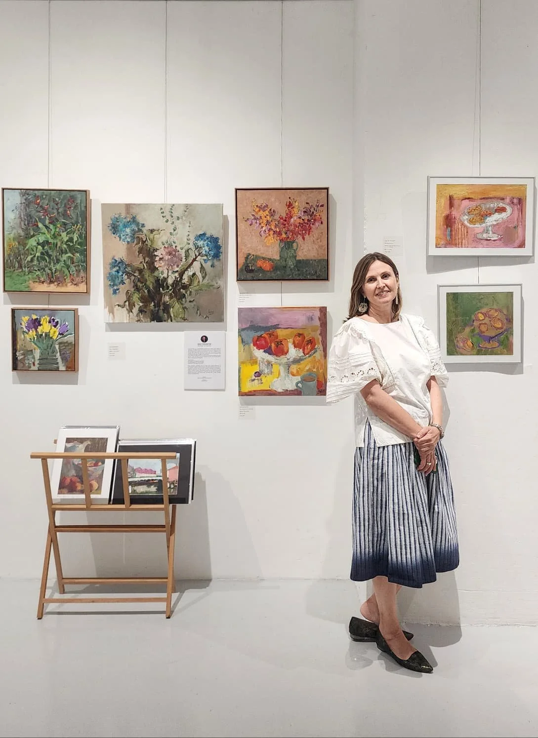 Canvas Connections artist Irina with her paintings