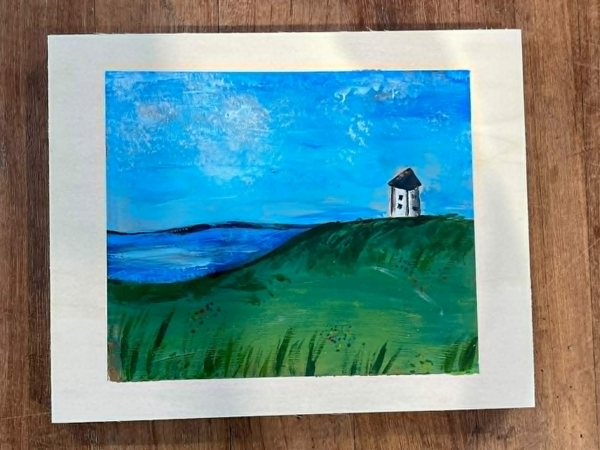 A colorful painting of a lighthouse on green grass with a blue sky and clouds in the background.