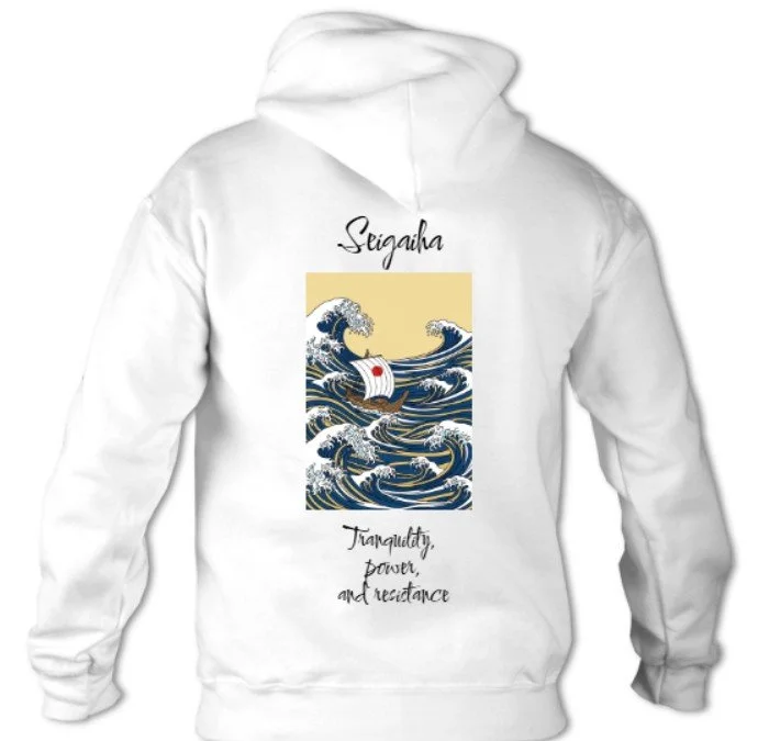 White hoodie with an artistic print of a Japanese wave, a boat, and the words 'Seigaha' and 'Tranquility, power, and resistance' engraved on it.