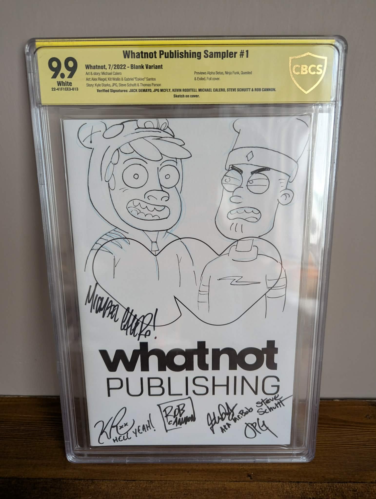 A comic-style drawing of two men, one wearing a hoodie and the other wearing a hat, with speech bubbles and signatures. The sign behind reads 'Whatnot Publishing' and mentions signing signatures.