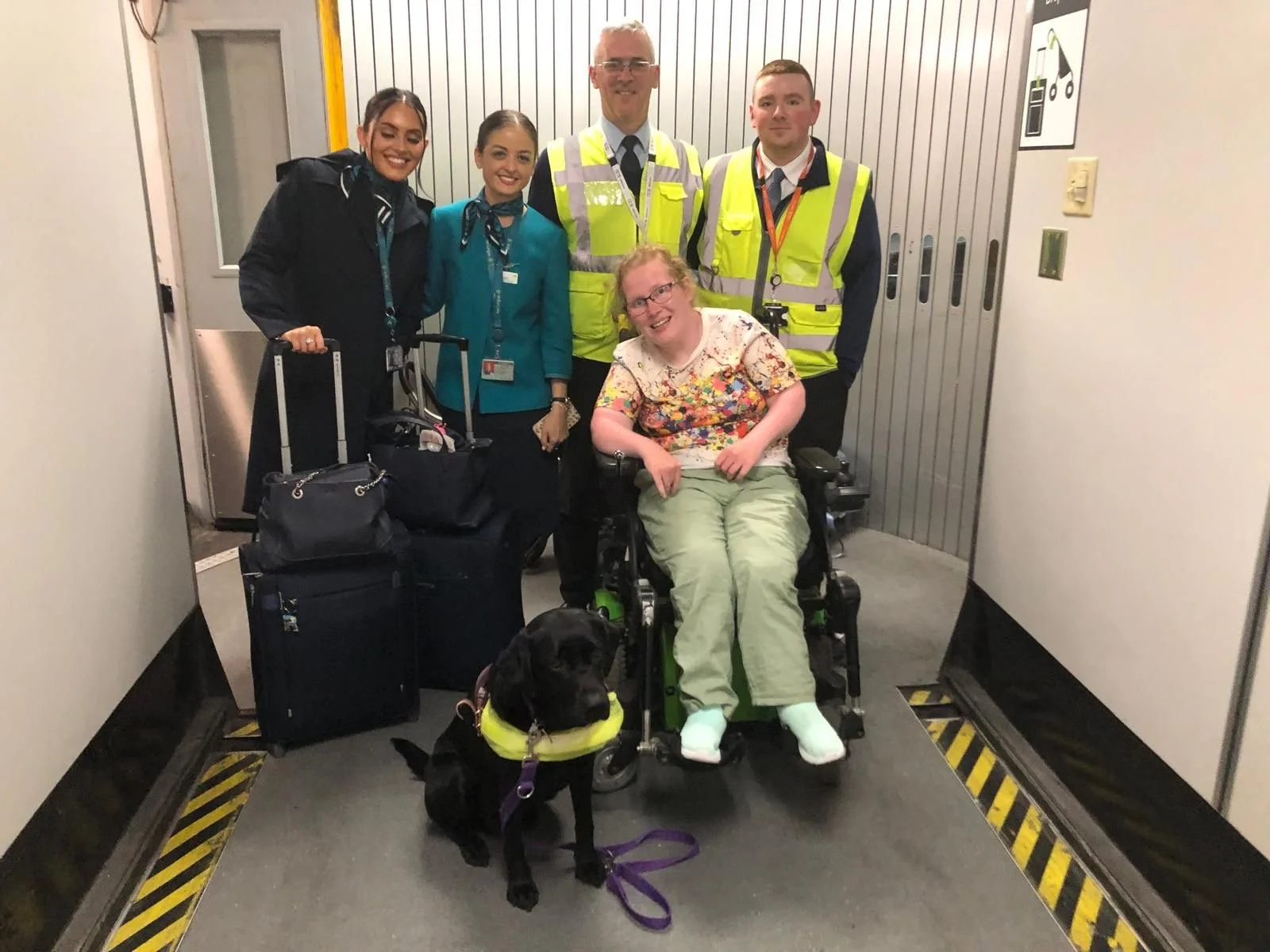 Woman, power wheelchair, task assistance dog, black labrador, dogs for disabled, aer lingus, DAA, dublin airport, ground staff