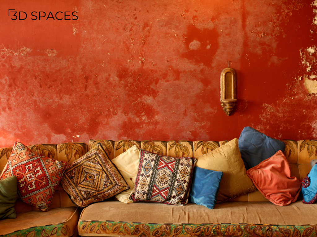 Rustic bohemian living room design with textured terracotta wall, vintage sofa, and colorful ethnic cushions for stylish home interiors.