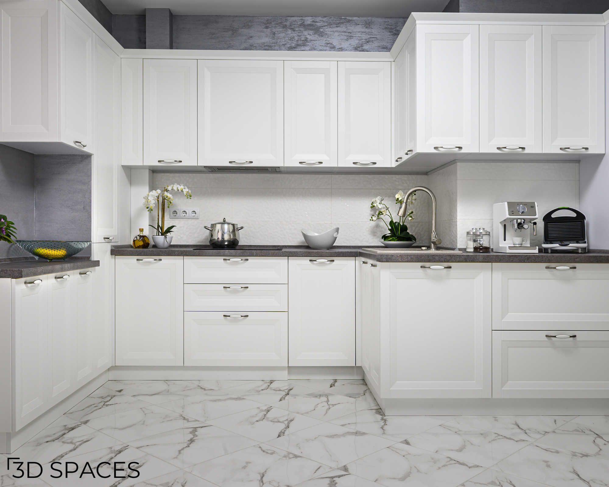 Modern white shaker cabinets with dark countertops and white marble-look floor tiles in a bright kitchen.