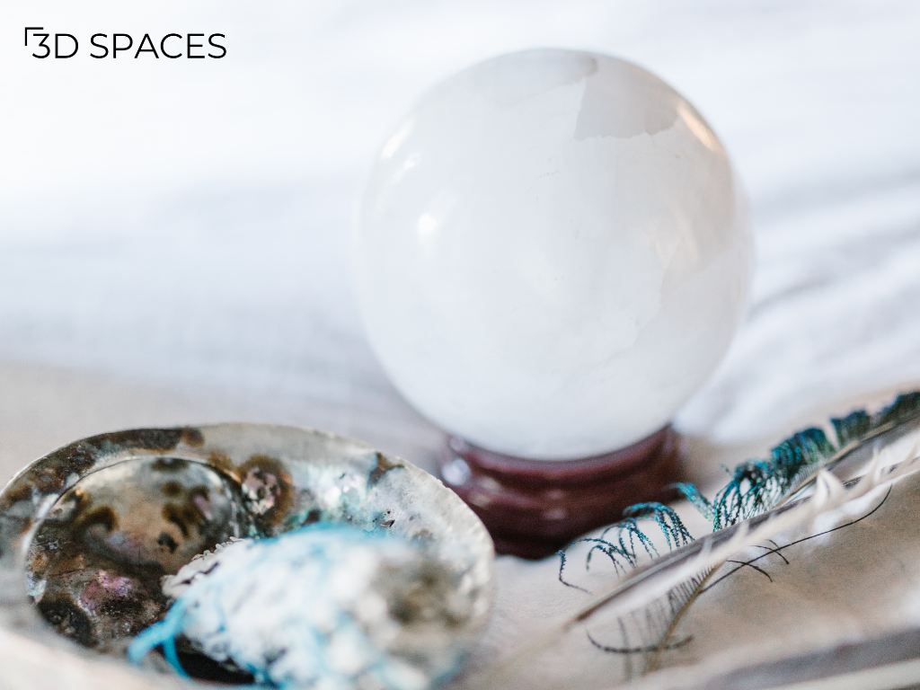 White crystal ball on a wooden stand with smudging bowl and feather for Vastu, Feng Shui, meditation, and home décor.