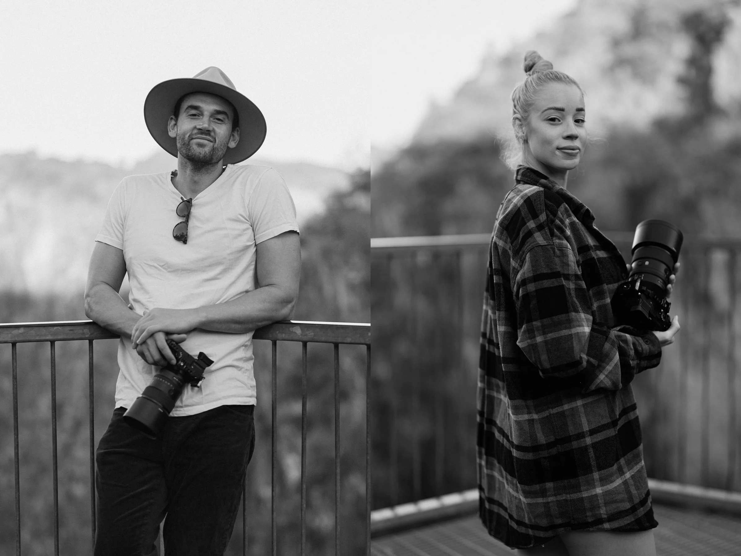 Hobart wedding photographer capturing A man wearing a hat and white t-shirt leaning against a railing, holding a camera, and a woman in a plaid shirt holding a camera, standing outdoors near a body of water with trees in the background.