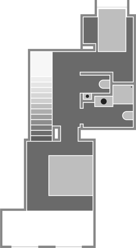 A floor plan of a residential space with multiple rooms, including a stairwell, bathroom, kitchen area, and living space.