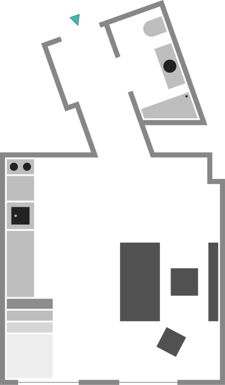 Grundriss einer Einzimmerwohnung mit Küche, Badezimmer und Wohnbereich.