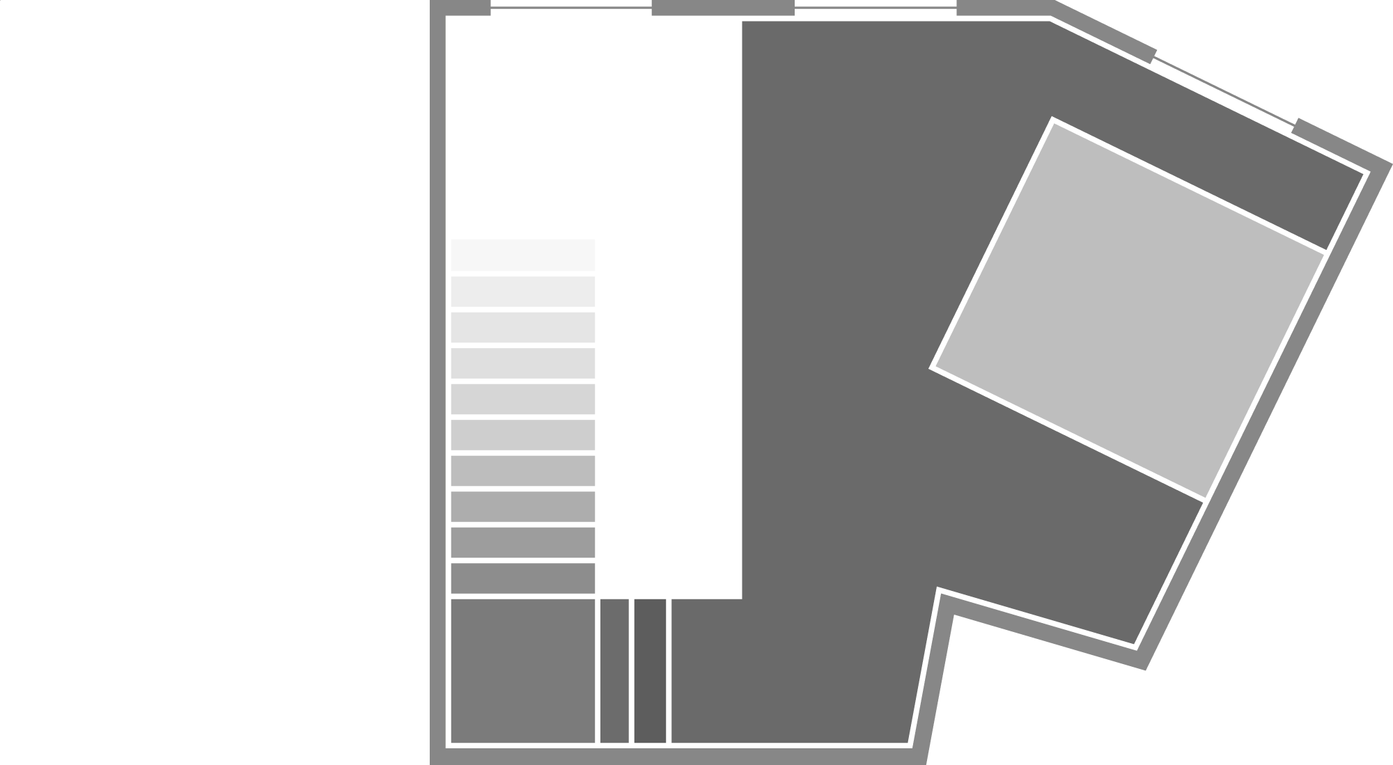Floor plan of a building with rooms, corridors, and staircases, including a large rectangular room, a smaller square room, and various corridors connecting them.