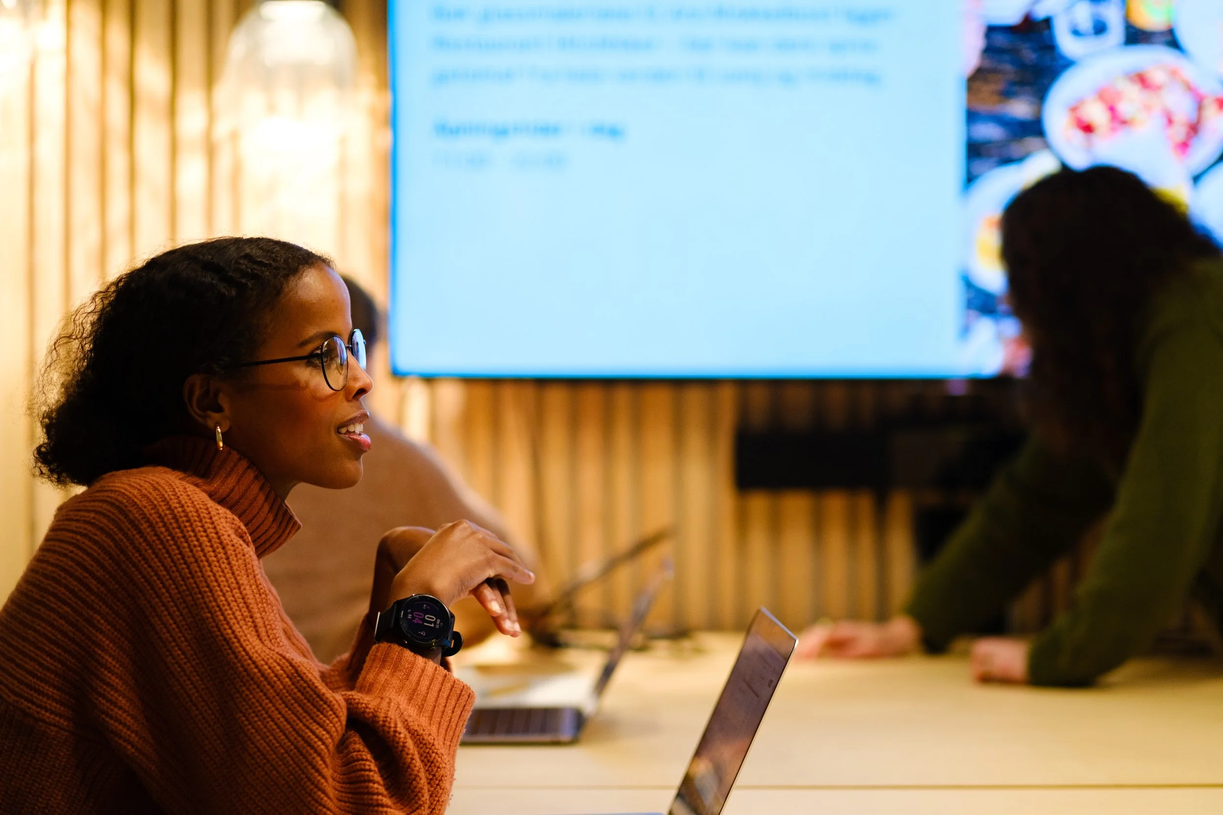Prosjektleder Zubeida Haji Hassan snakker med kollegaer i et møterom.