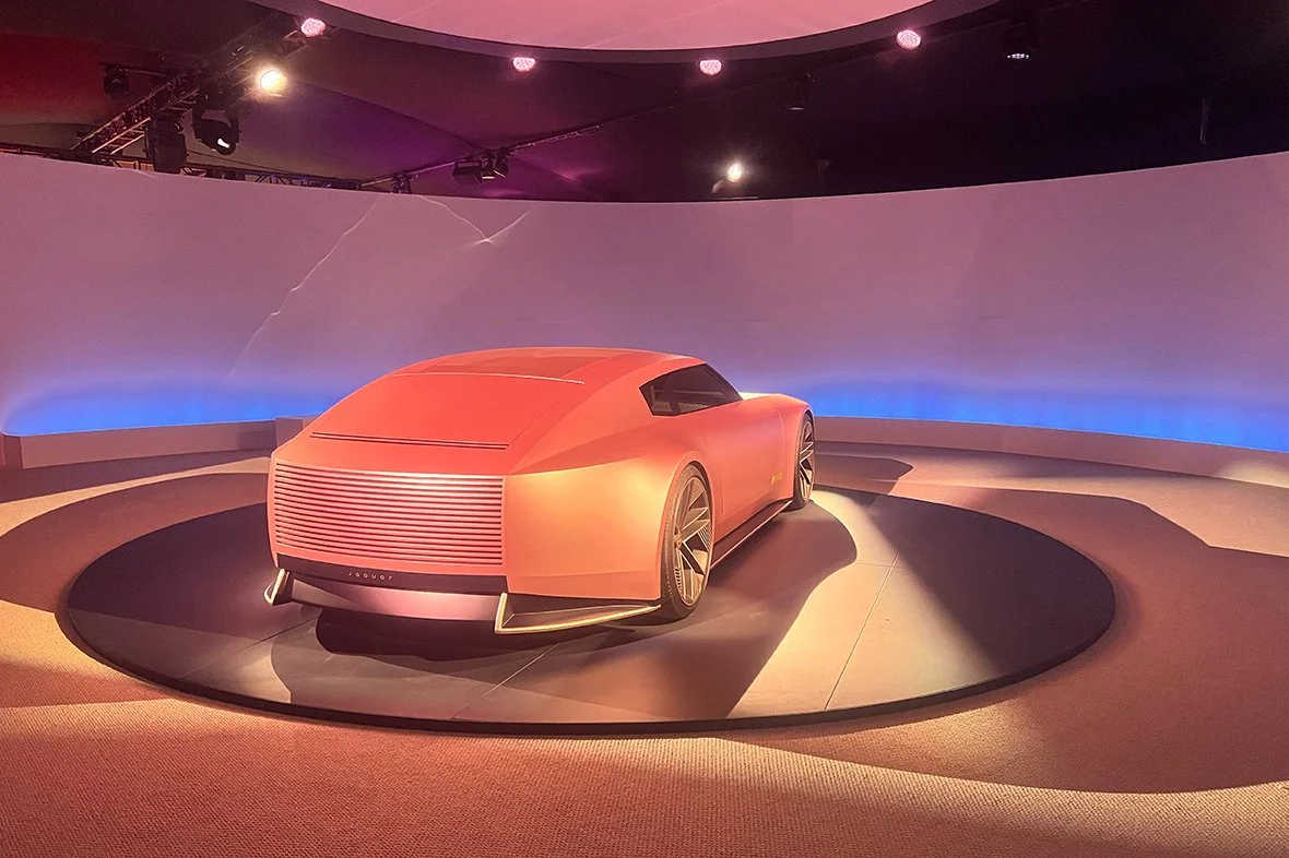 Copper Jaguar Type 00 EV concept car on a circular turntable stage at the Jaguar Art Miami brand activation