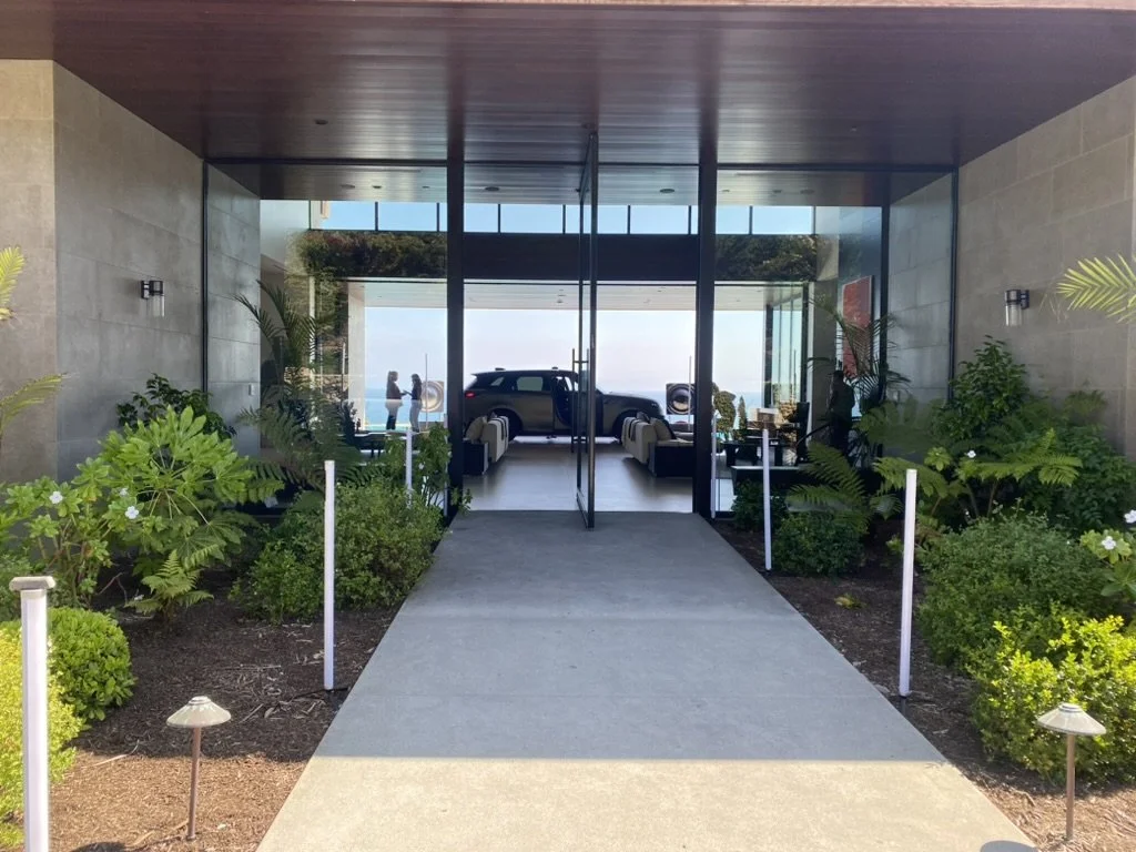 Entrance walkway leading to the modern glass-front venue for the Land Rover Defender Tour activation