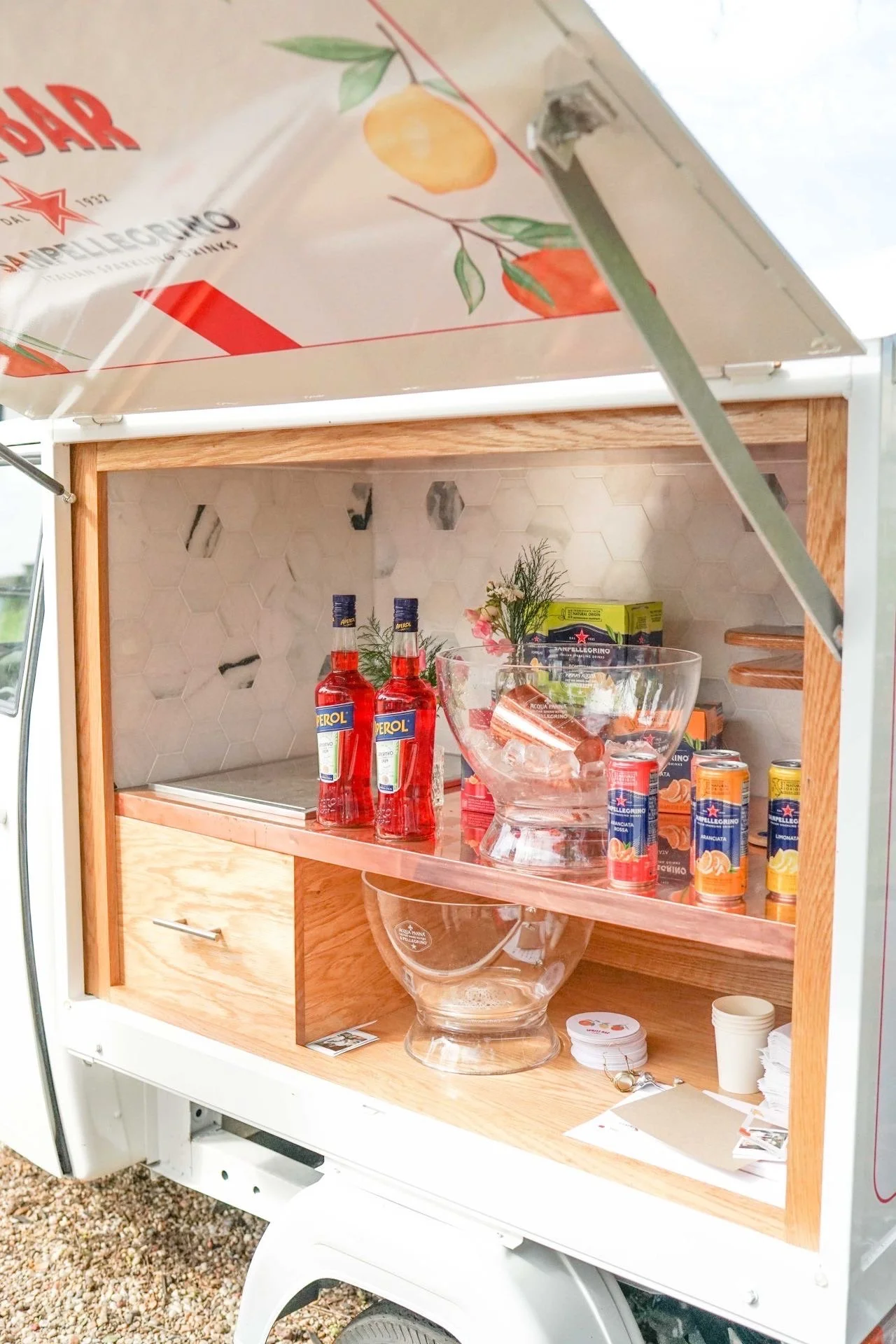 Styled Italian market cart displaying San Pellegrino sparkling drink bottles at the SXSW product sampling activation