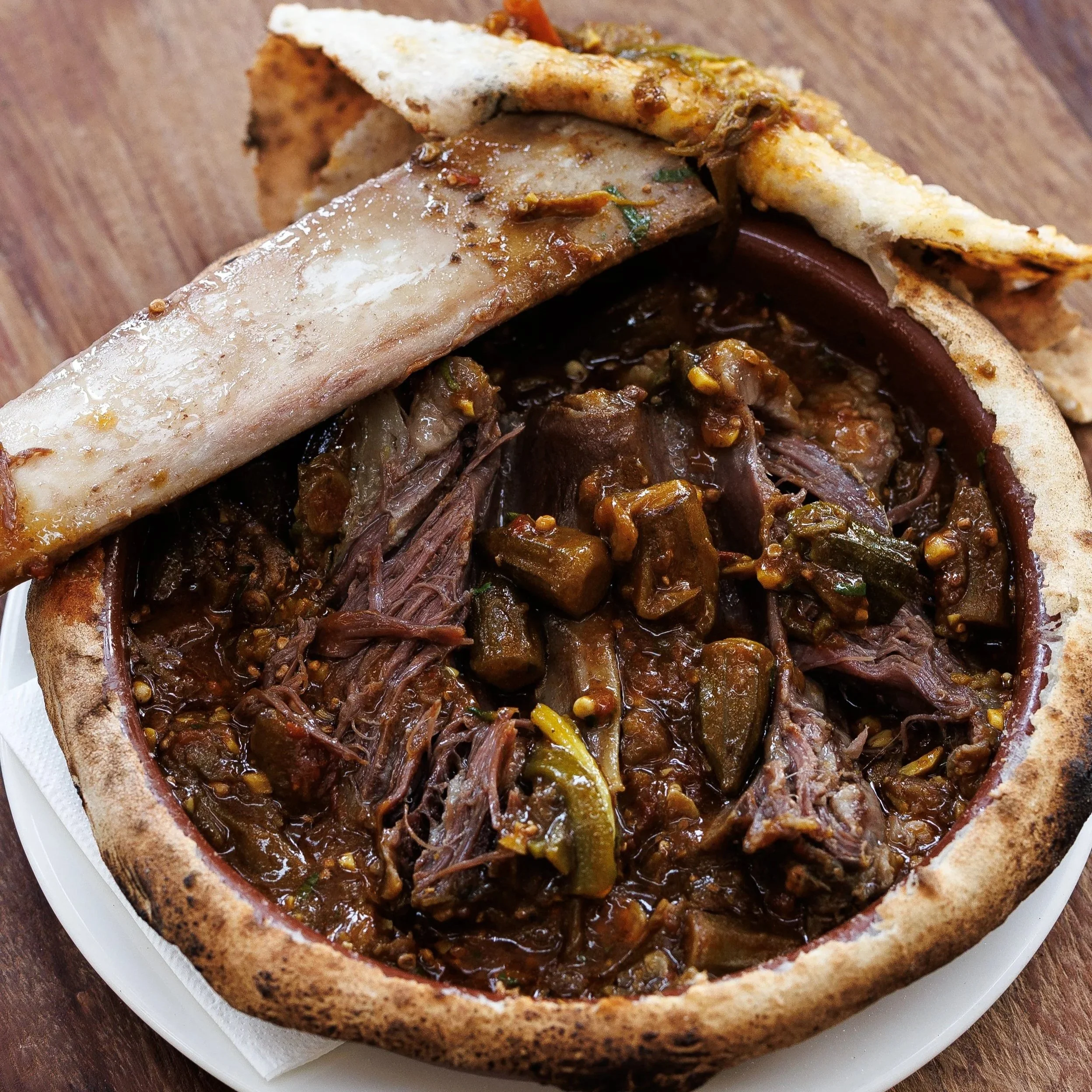 Khoresh-E Bamieh-Ye  Gav 
 / low cooked beef short rib, bamia and tomato sauce stew / 159 AED