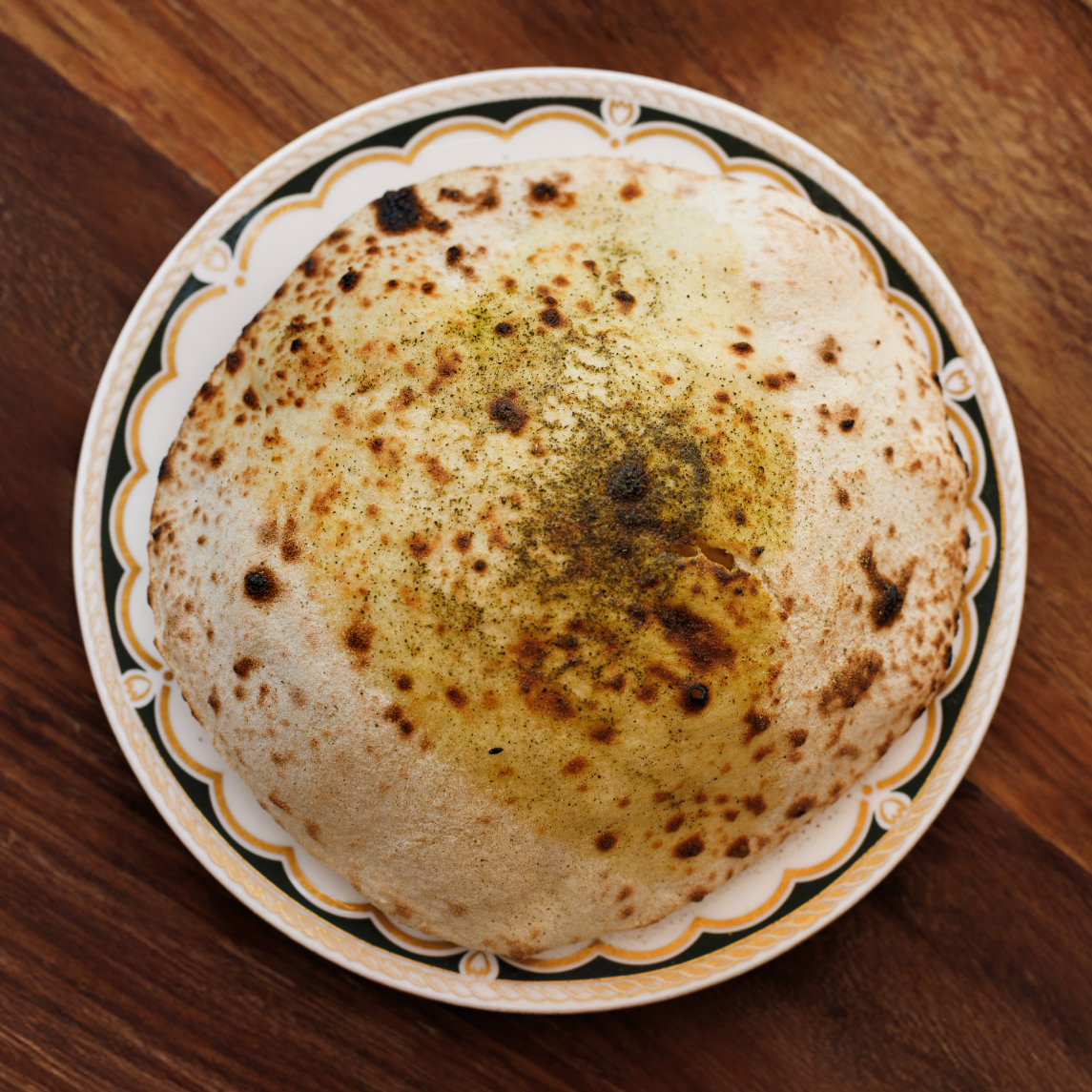 House Flatbread / signature sourdough wood-fired bread / 12 AED