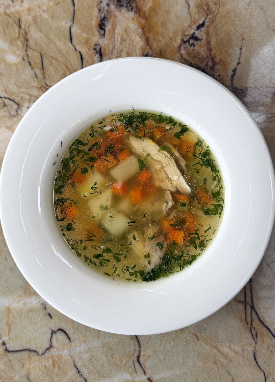 Consommé-ye Morgh / rich chicken broth, parsley, dill, root vegetables / AED 39