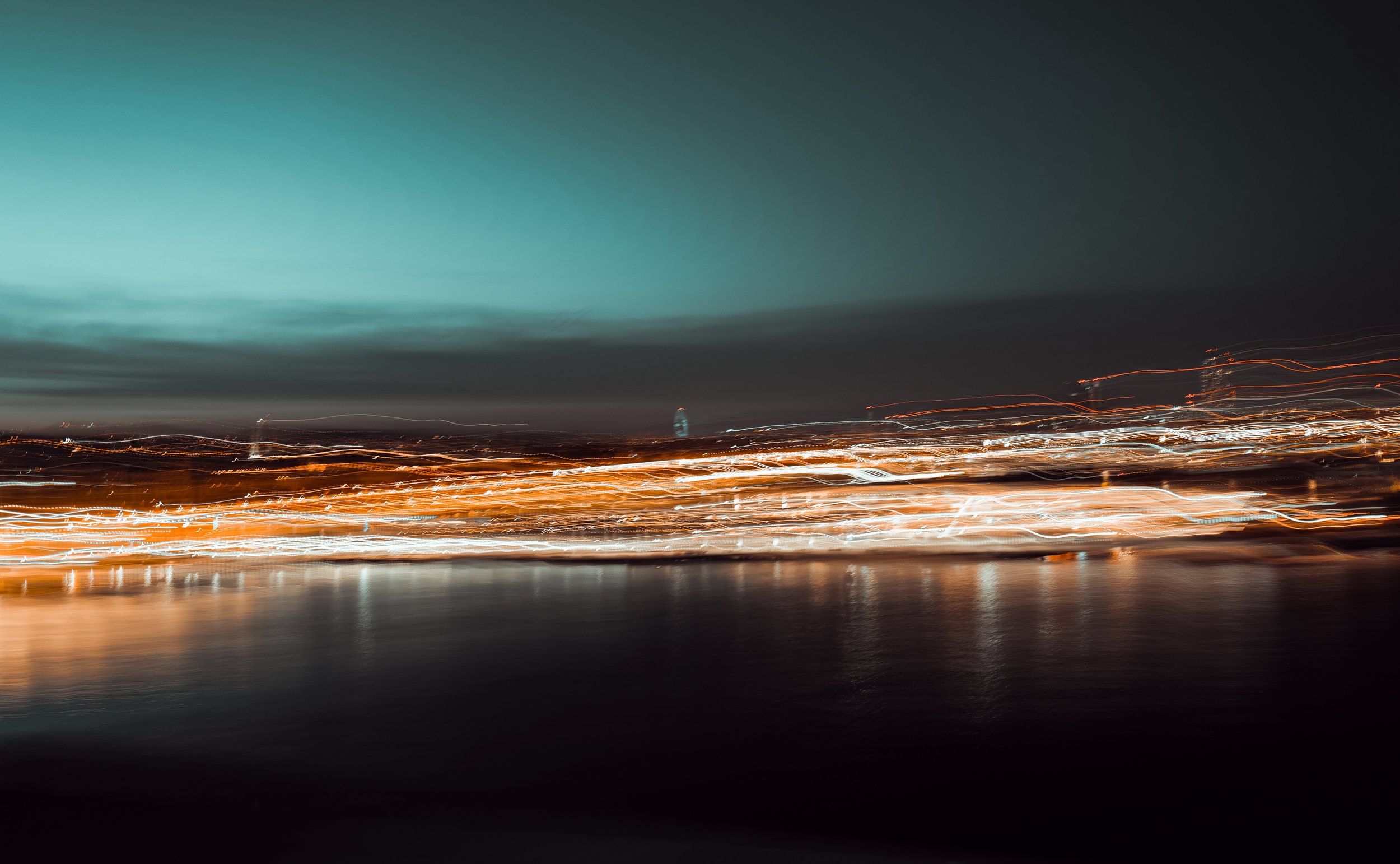 Abstract night cityscape with blurred lights and dark sky.