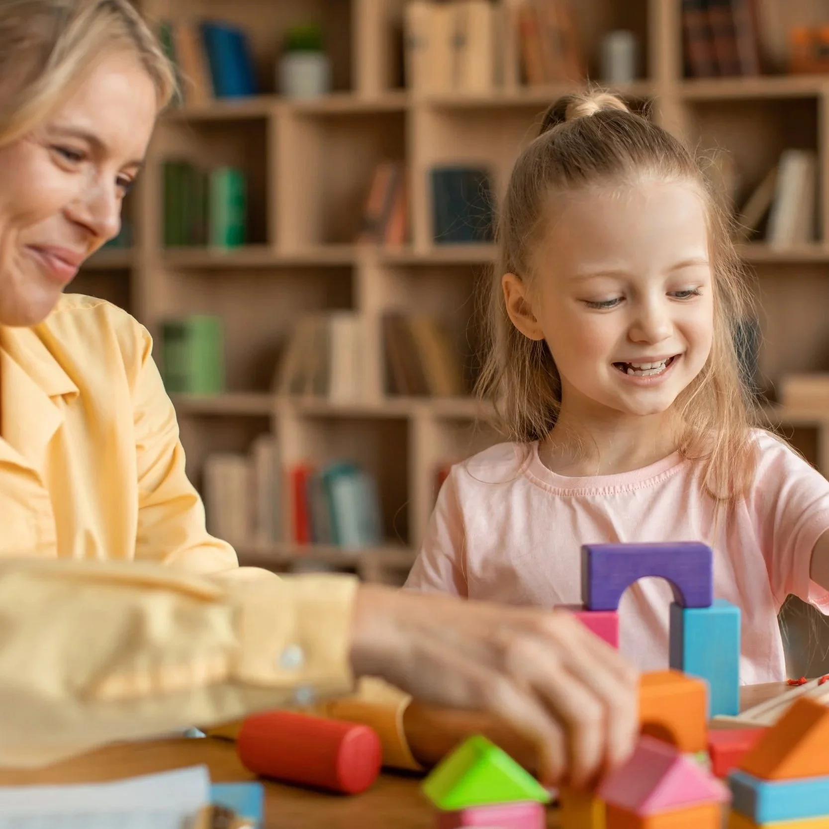 Mother playing with blocks with her 4 year old daughter