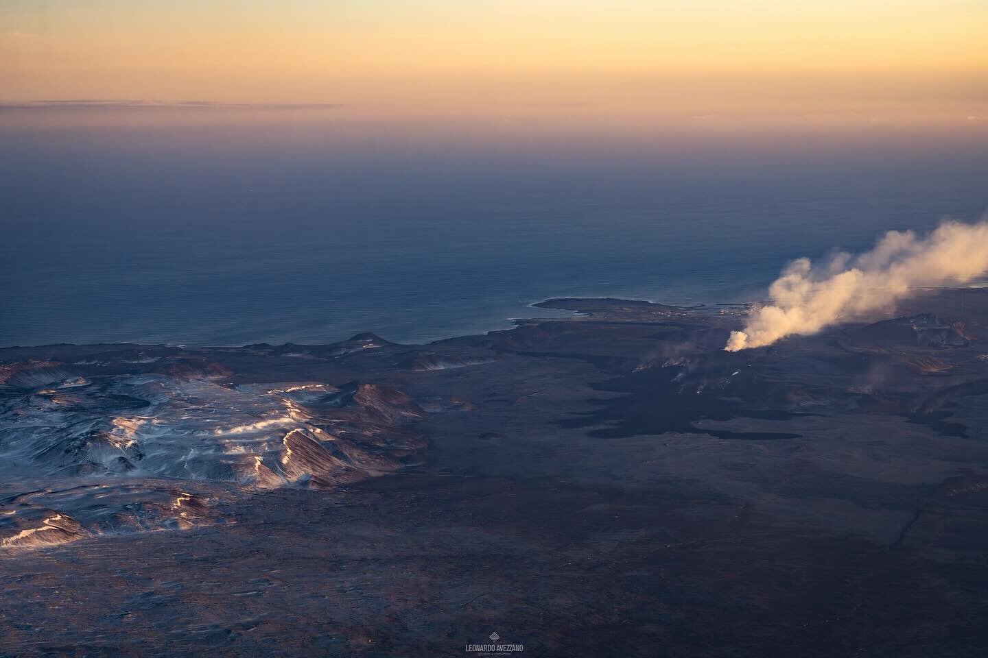 The sense of infinity of Iceland captured from the airplane while flying south. The contrast of the blue ocean and the sky in the golden hours, the moon rises while the volcano keeps spurring lava, flooding the area. 

(In the pictures: 1. 2. Grindav