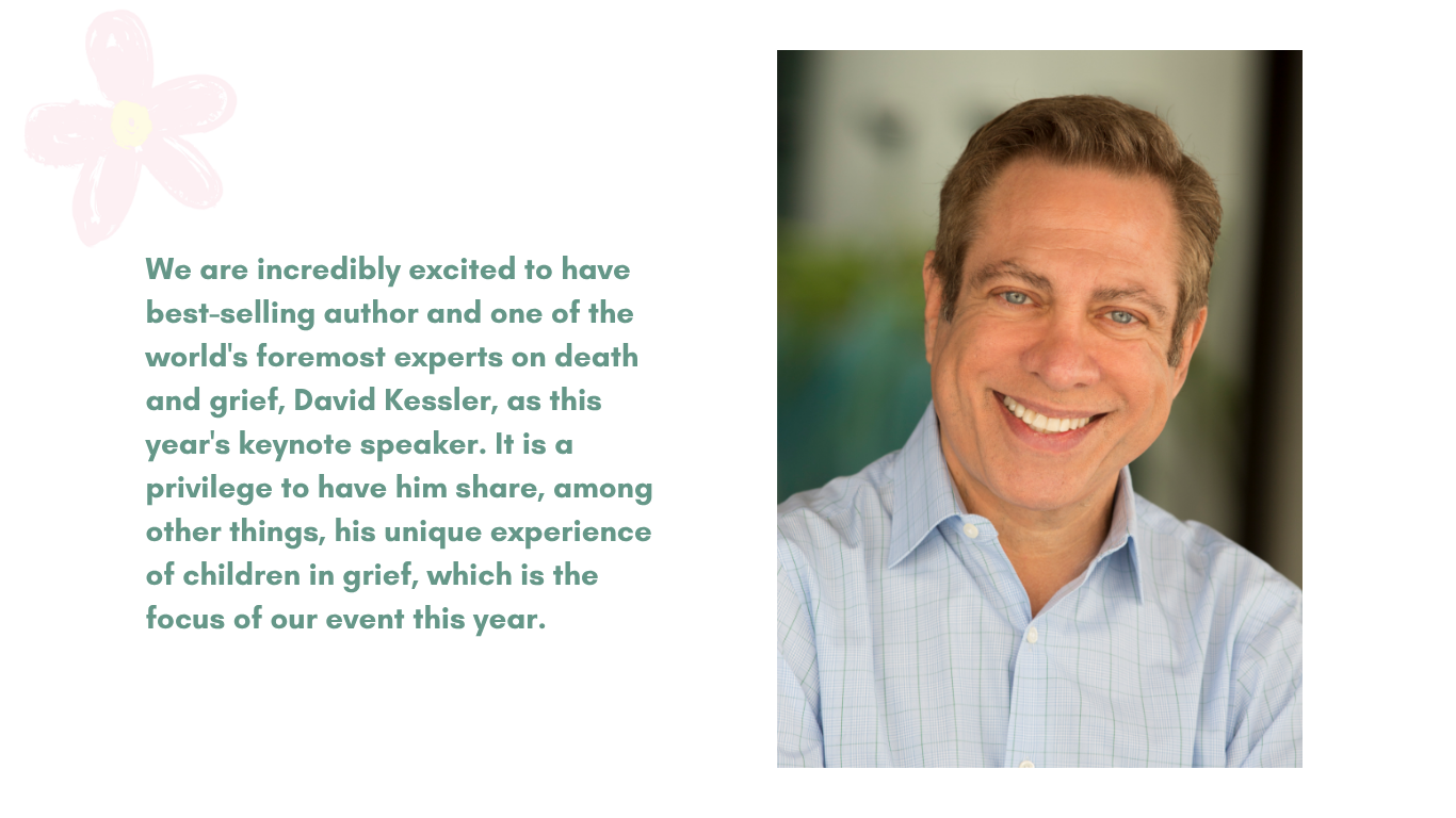 A smiling man wearing a light blue checkered shirt.