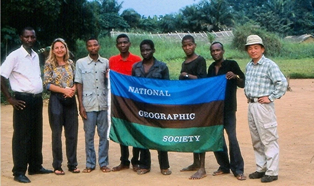Group of people holding National Geographic Expedition flag