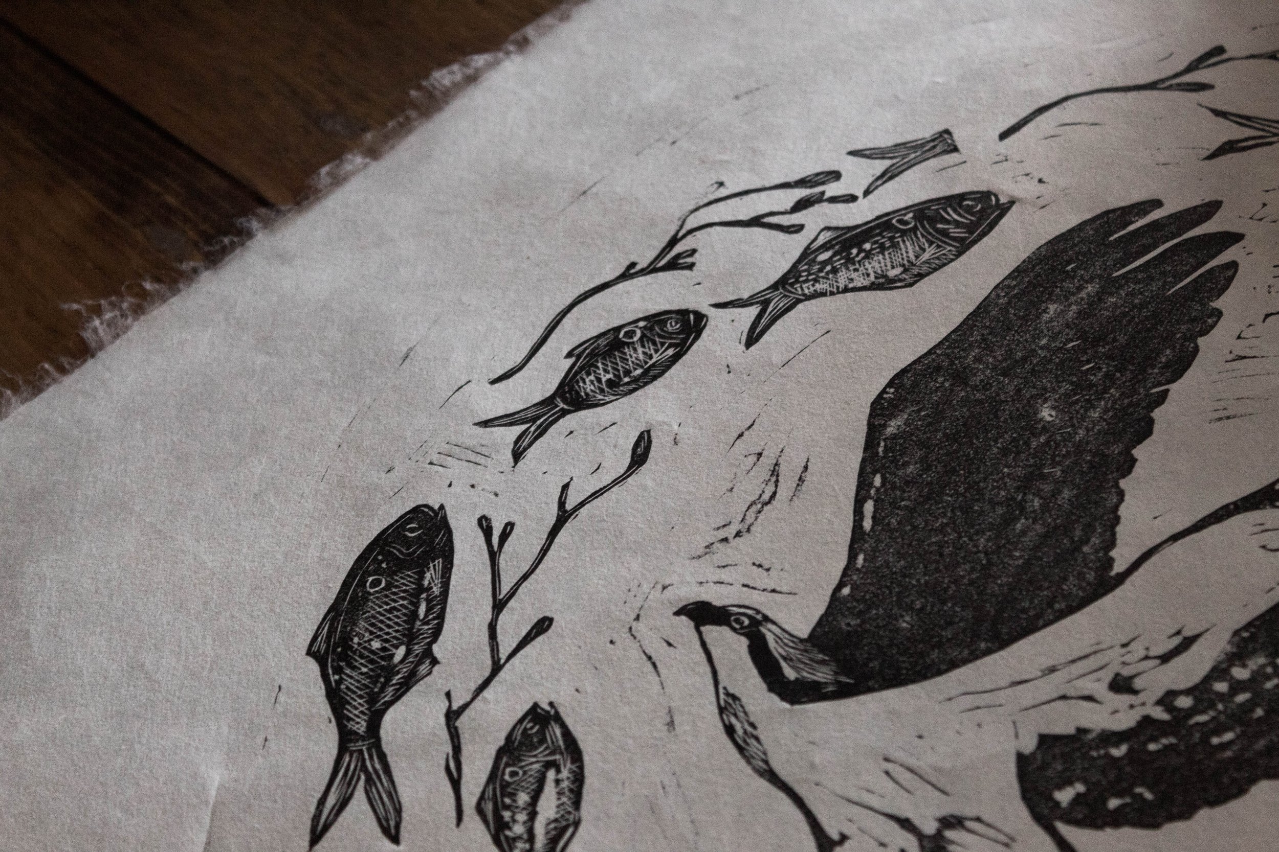 Detail of linocut print showing osprey and fish