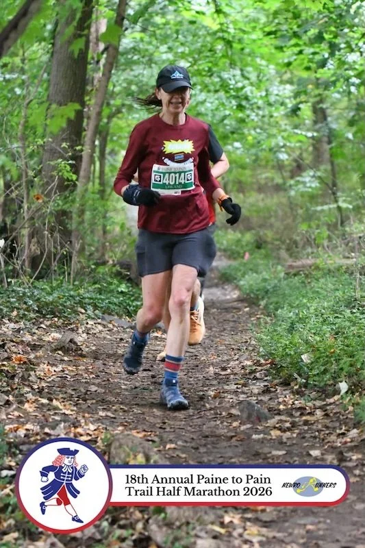 A runner in a red shirt on a trail
