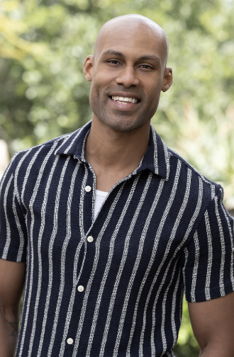 Smiling man in striped shirt outdoors