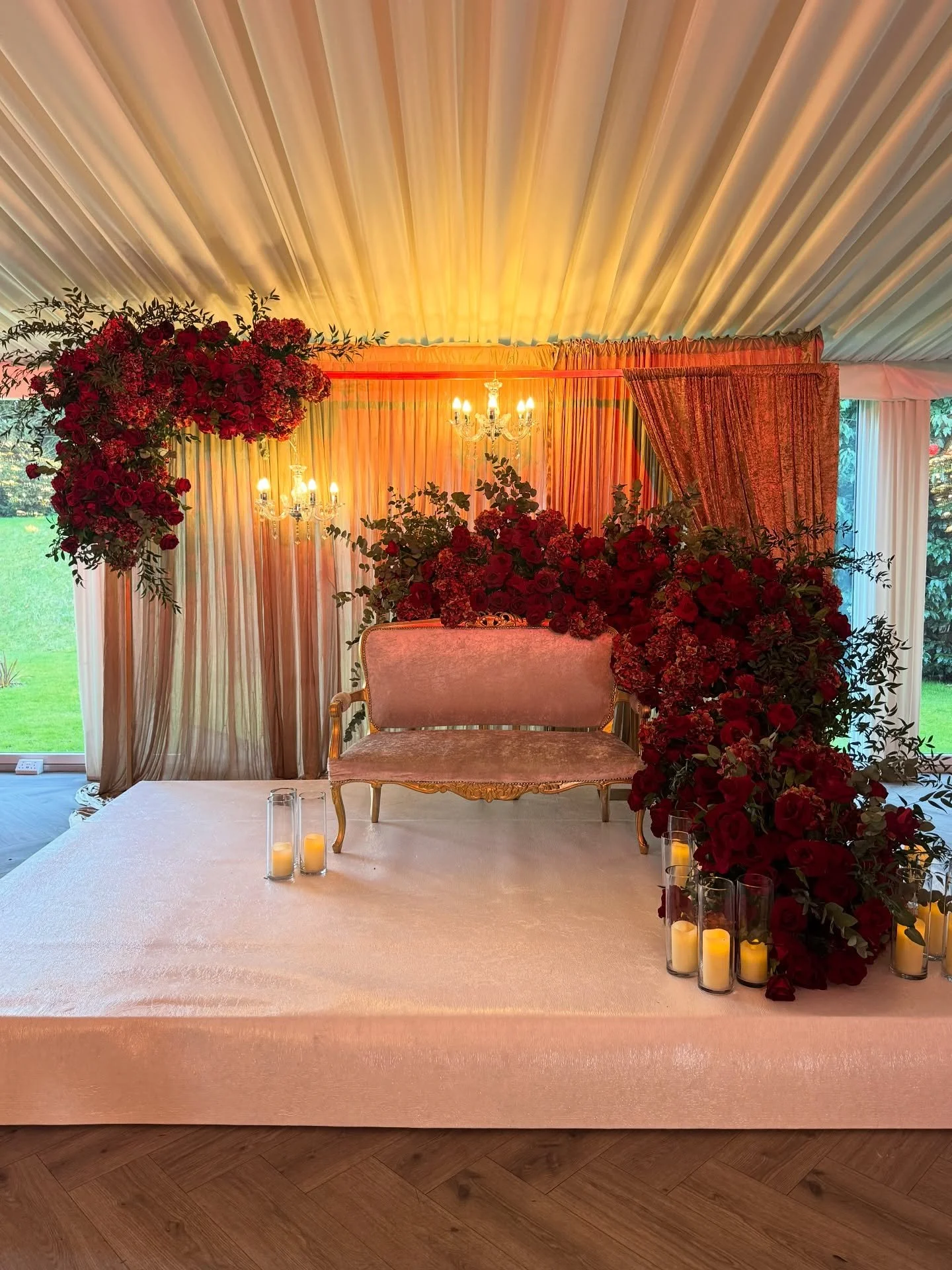 From whimsical fresh greenery to the rich embrace of lush red roses, their evening reception blossomed with a captivating blend of burgundy hydrangeas and velvety red roses &mdash; a symphony of blooms that set the stage for an utterly romantic night