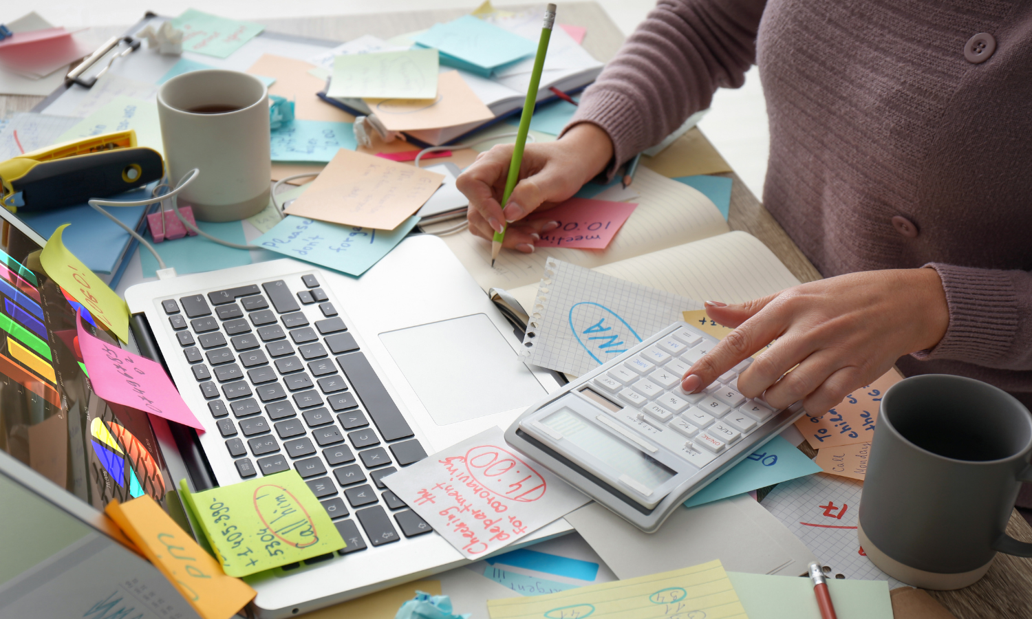 A woman at a desk working through her to-do list