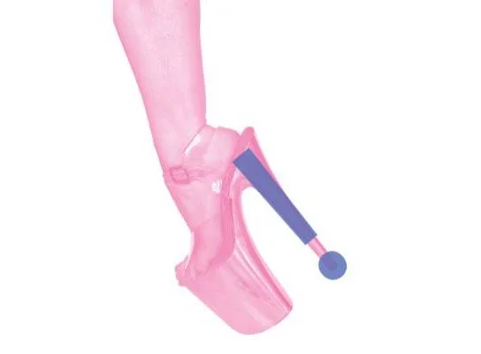 photo with a white background and a pink hued calf and foot, side view. On the fot is a very high platform stripper shoe with a blue exclamation mark over the long heel.