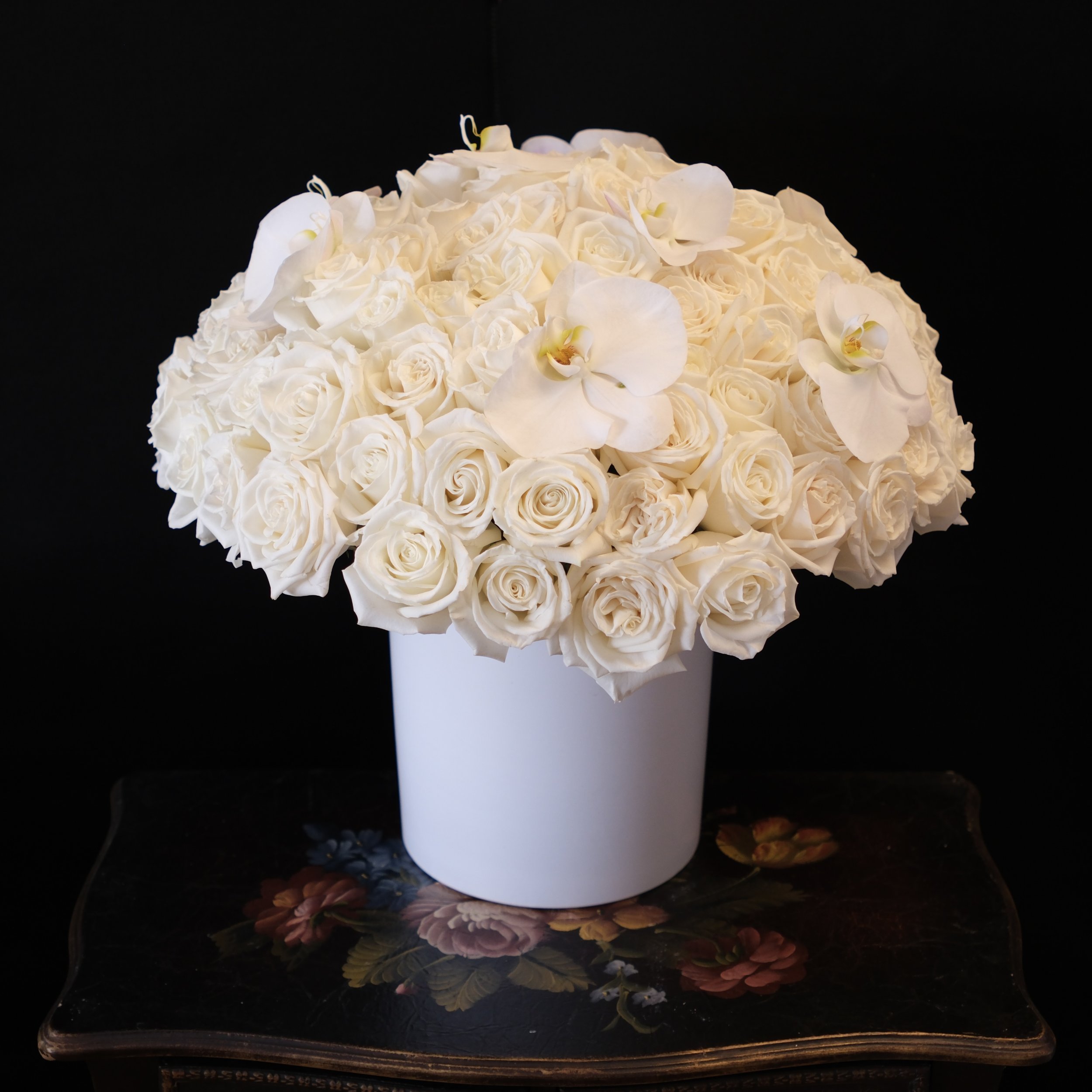 white roses with white orchids