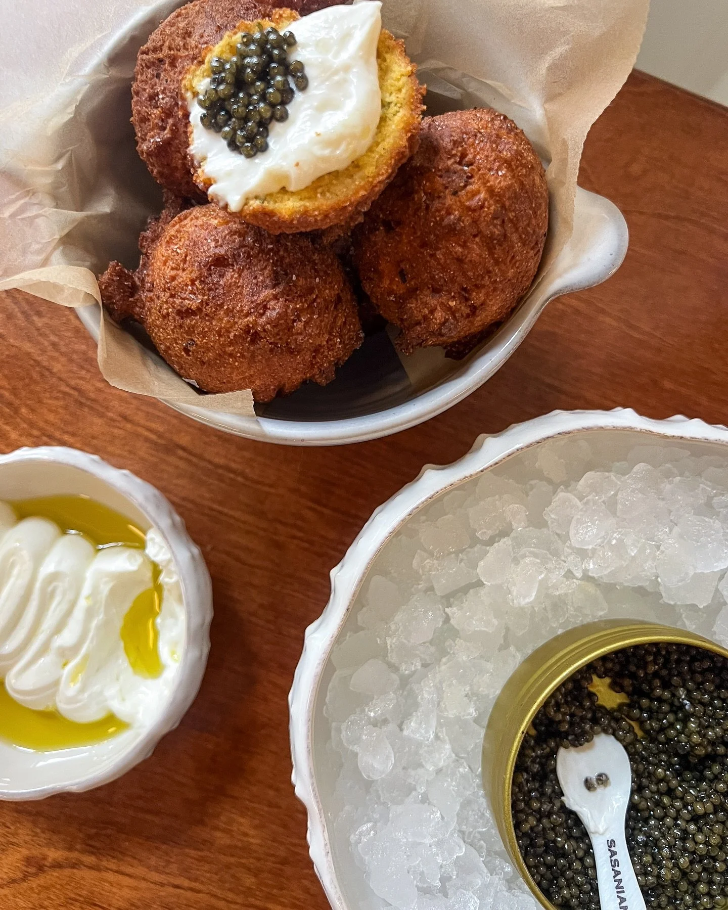 Caviar service with hush puppies &amp; lemon ricotta. A favorite highbrow lowbrow snack!